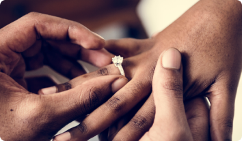 an engagement ring being put on a finger