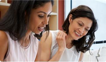 a woman with her hand on another woman's shoulder