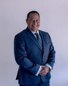 a man in a suit smiling