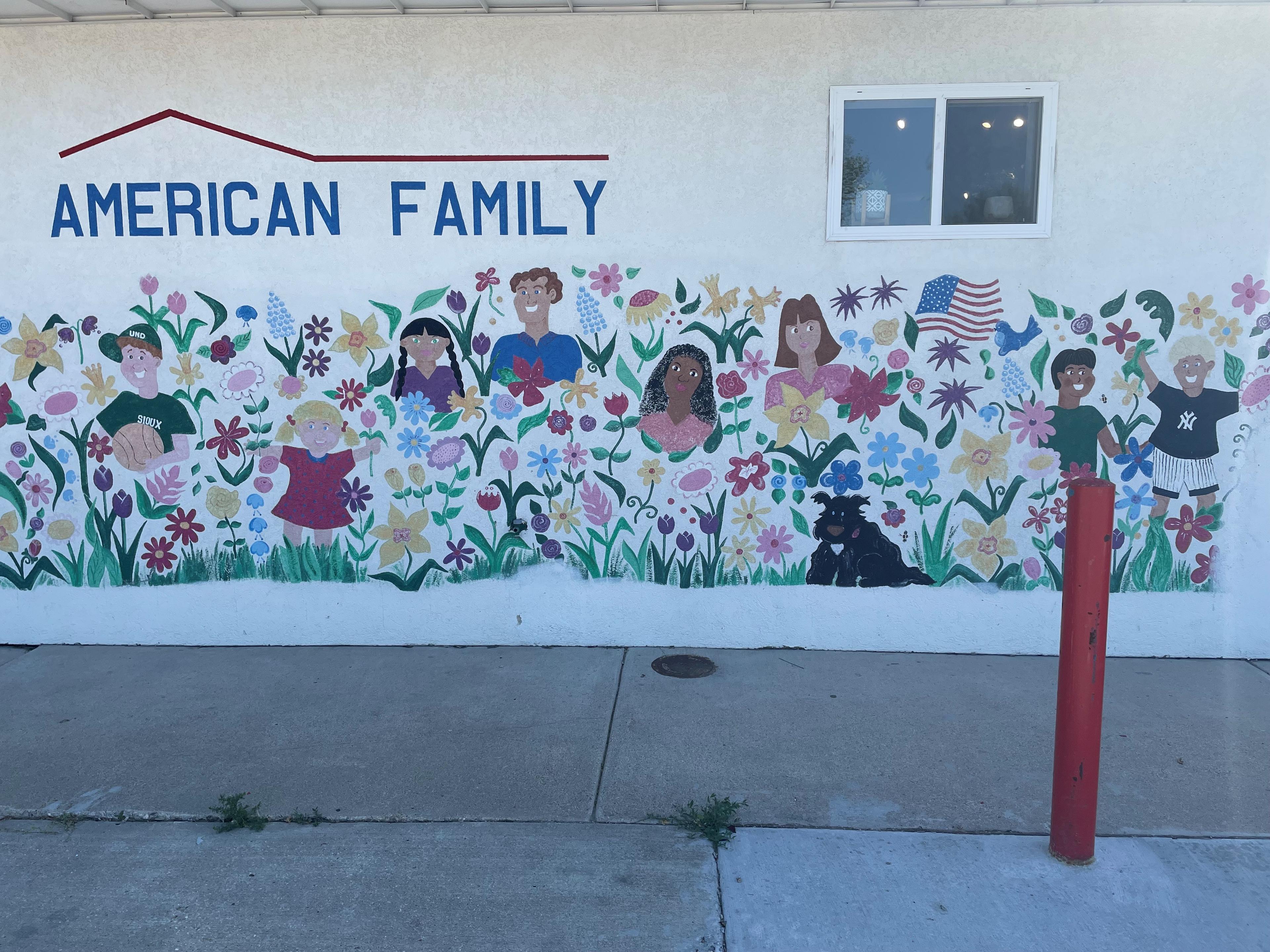 a wall with a mural of flowers