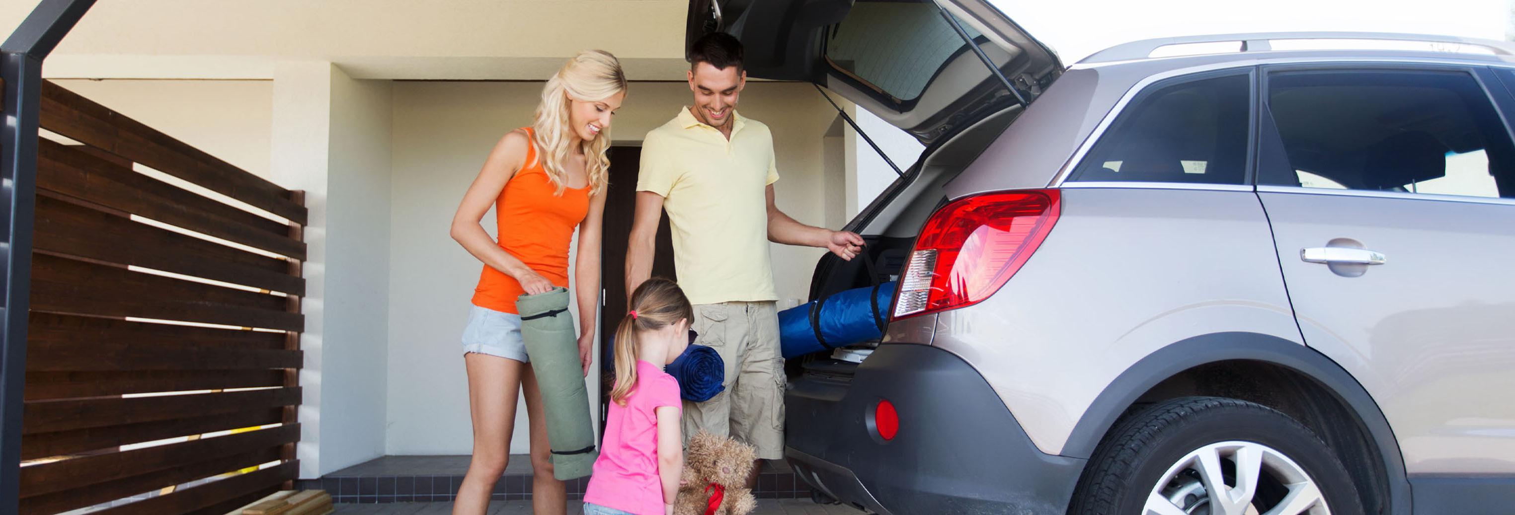 a family unpacking a vehicle