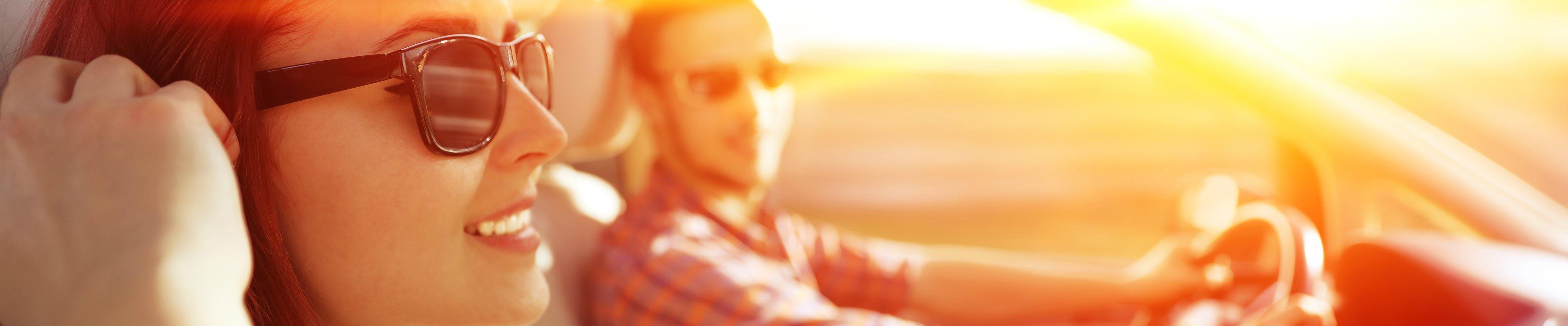 Image of friends driving during sunset.