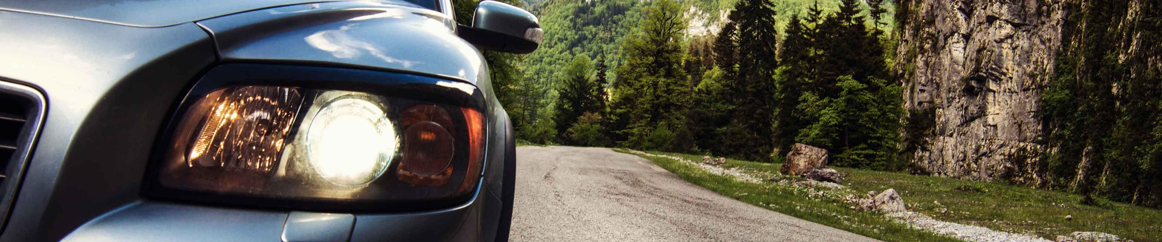 car driving down the road with a close up of its headlight