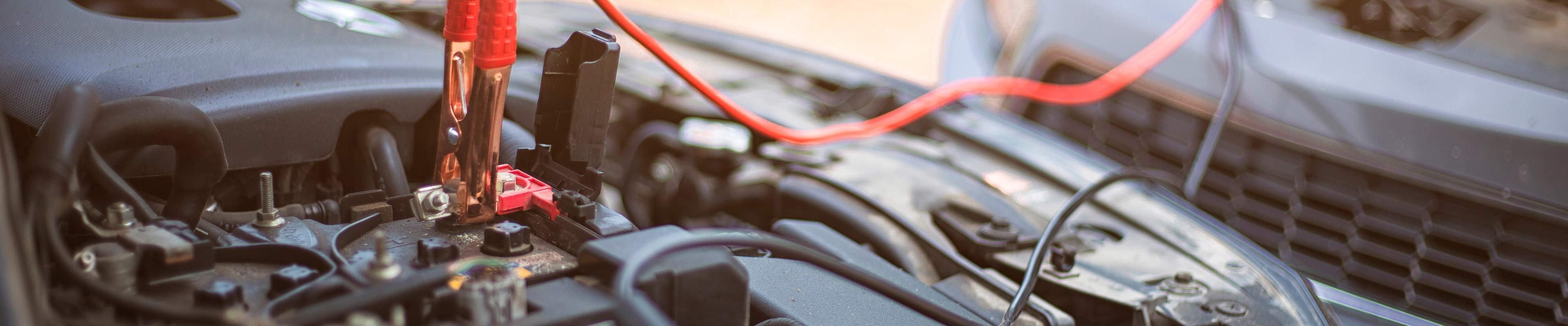 Image of two cars and jumper cables.