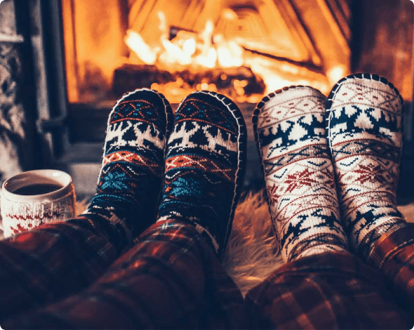 Drinking hot drink by the fireplace