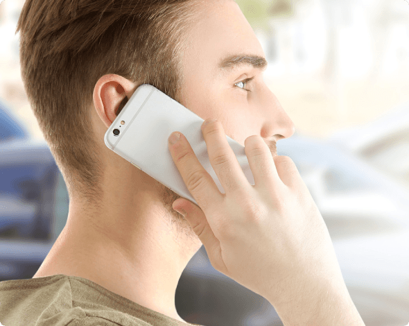 Young man talking on phone after an accident with uninsured driver