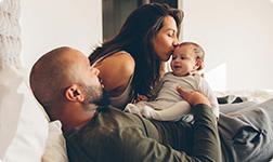 a man and woman holding a baby