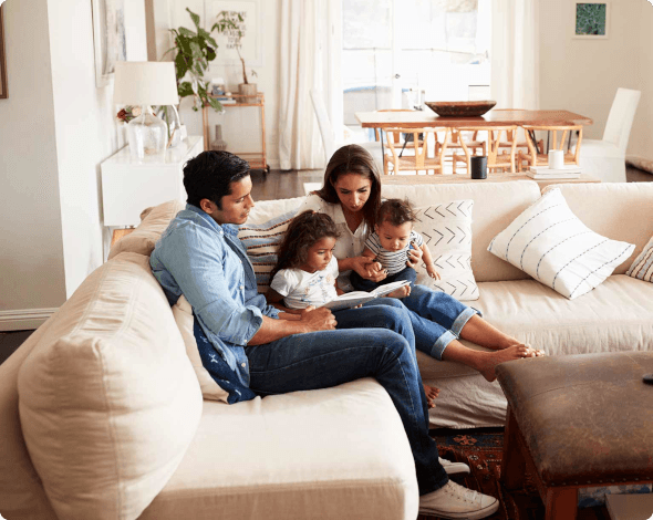 a family of four gathered on a couch