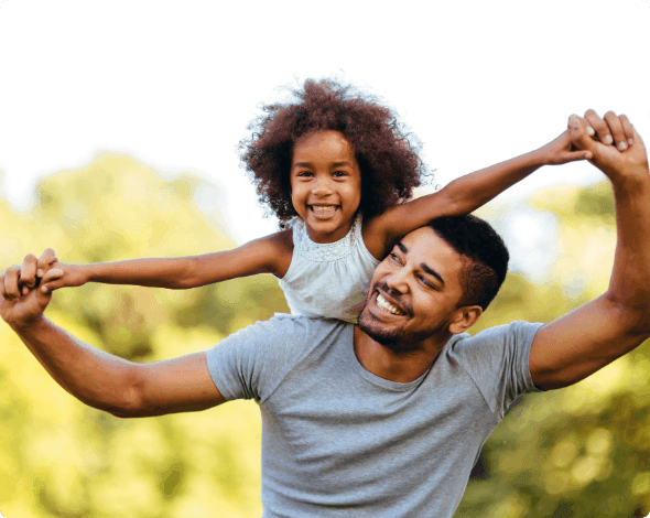 A father holding his child on his shoulders.