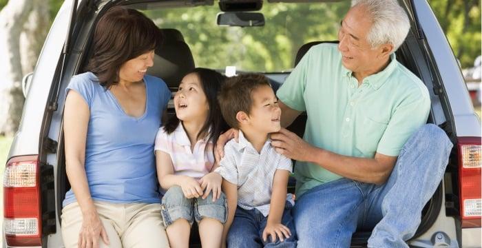 a family sitting in the back of a car